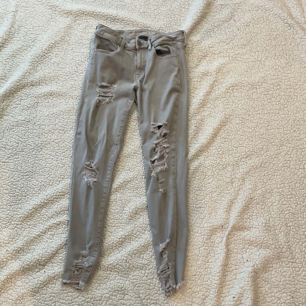 Grey denim distressed jeans.